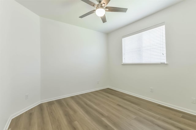 21320 Heritage Forest Ln, Porter, TX 77365 - spare room with a ceiling fan, wood finished floors, and baseboards