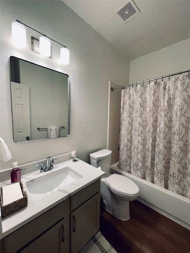21320 Heritage Forest Ln, Porter, TX 77365 - full bath featuring a textured wall, wood finished floors, shower / bath combo, toilet, and vanity