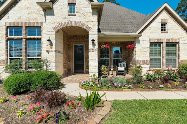 40377 Mostyn Dr, Magnolia, TX 77354 - view of front of home featuring stone siding, covered porch, a shingled roof, and brick siding