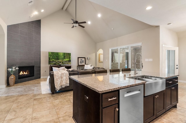 40377 Mostyn Dr, Magnolia, TX 77354 - kitchen with stainless steel dishwasher, high vaulted ceiling, a sink, an island with sink, and a ceiling fan