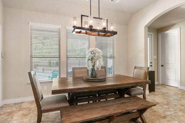 40377 Mostyn Dr, Magnolia, TX 77354 - dining area featuring arched walkways, a chandelier, healthy amount of natural light, and baseboards