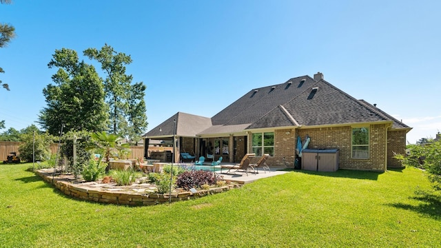 40377 Mostyn Dr, Magnolia, TX 77354 - rear view of house featuring a patio area, brick siding, a hot tub, a chimney, and roof with shingles