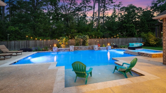 40377 Mostyn Dr, Magnolia, TX 77354 - pool at dusk with a patio area, a fenced backyard, and a pool with connected hot tub