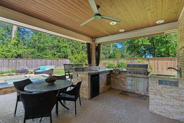 40377 Mostyn Dr, Magnolia, TX 77354 - view of patio with a grill, exterior kitchen, a fenced backyard, a sink, and a ceiling fan