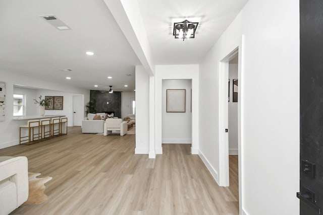 foyer with light wood-style flooring, baseboards, visible vents, and recessed lighting