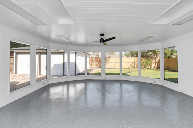 unfurnished sunroom featuring ceiling fan