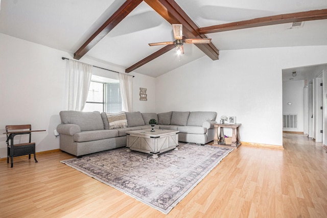 living room with light wood-style flooring, visible vents, and vaulted ceiling with beams