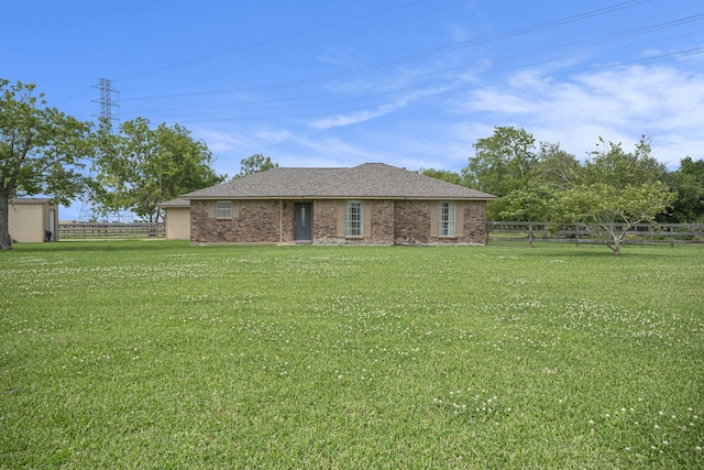 single story home featuring a front lawn and a fenced backyard