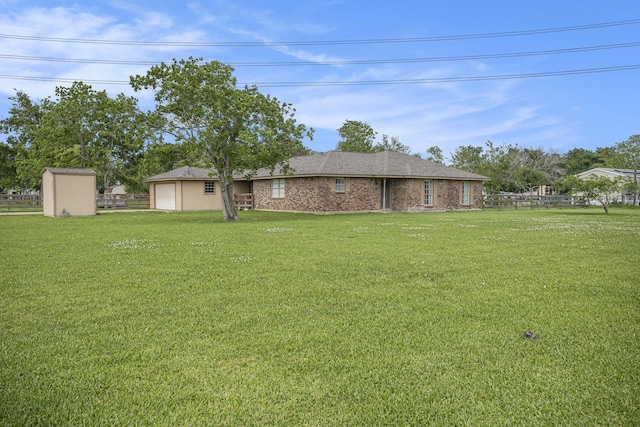 view of yard featuring a garage and fence