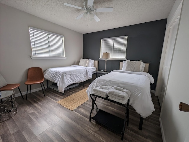 16716 Fletcher Christian Rd, Jamaica Beach, TX 77554 - bedroom with wood finished floors, a textured ceiling, ceiling fan, and multiple windows
