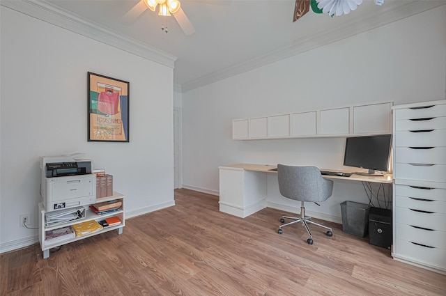 home office featuring crown molding, light wood-style floors, ceiling fan, and baseboards