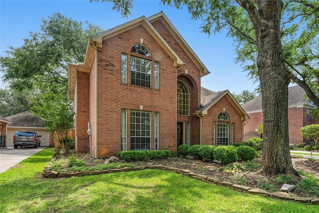traditional home featuring brick siding and a front lawn