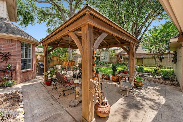 view of patio featuring a gazebo and a fenced backyard