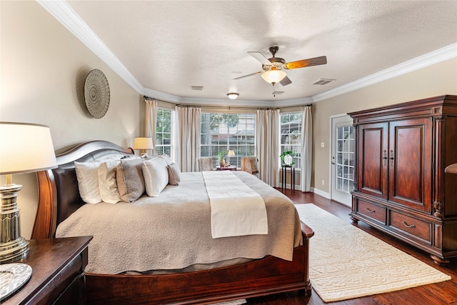 bedroom with baseboards, visible vents, ornamental molding, and dark wood-type flooring