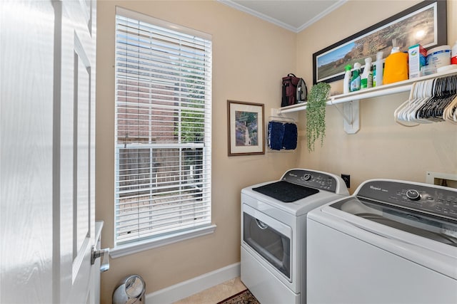 laundry room featuring washing machine and clothes dryer, crown molding, laundry area, baseboards, and tile patterned flooring