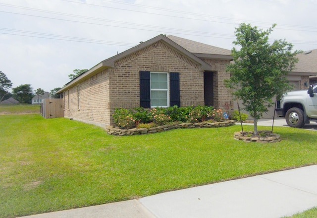 1634 William Scott St, Baytown, TX 77523 - view of front of home with brick siding and a front yard