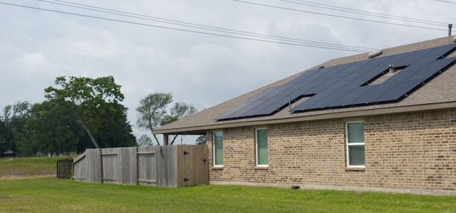 1634 William Scott St, Baytown, TX 77523 - view of property exterior featuring brick siding, roof mounted solar panels, and roof with shingles