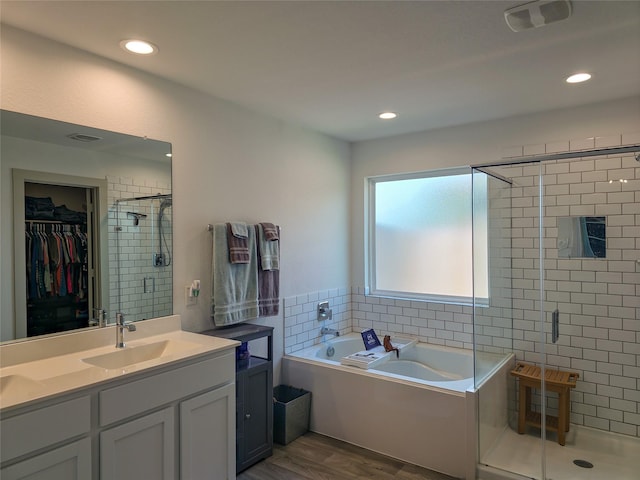 1634 William Scott St, Baytown, TX 77523 - bathroom with a stall shower, a bath, wood finished floors, vanity, and a spacious closet