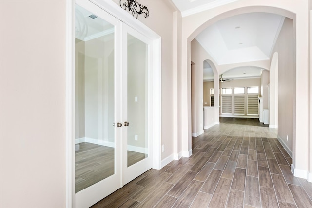 23446 Timbarra Glen Dr, New Caney, TX 77357 - hall featuring crown molding, arched walkways, baseboards, and dark wood-type flooring
