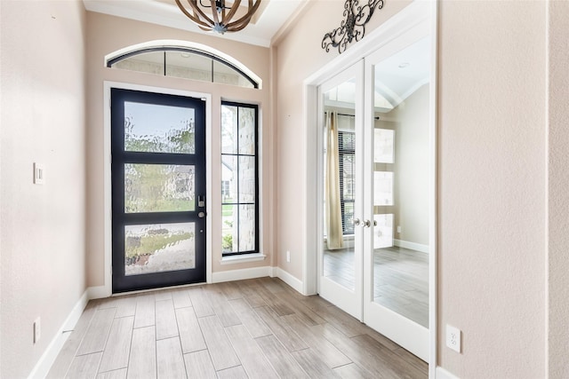 23446 Timbarra Glen Dr, New Caney, TX 77357 - entryway featuring ornamental molding, a wealth of natural light, wood finished floors, and french doors