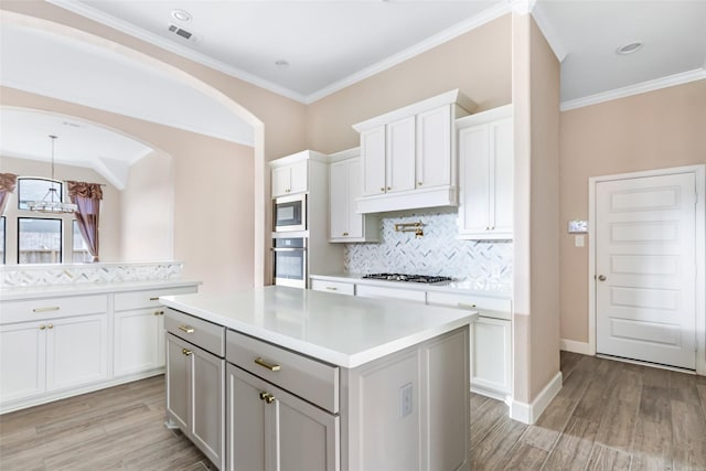 23446 Timbarra Glen Dr, New Caney, TX 77357 - kitchen featuring stainless steel appliances, backsplash, light wood-style floors, and light countertops