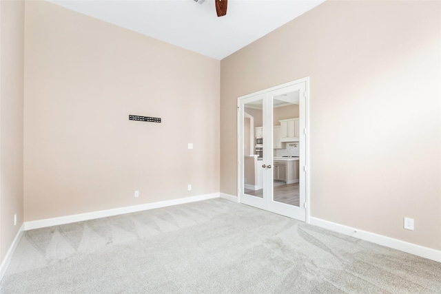 23446 Timbarra Glen Dr, New Caney, TX 77357 - unfurnished room with baseboards, a ceiling fan, and light colored carpet