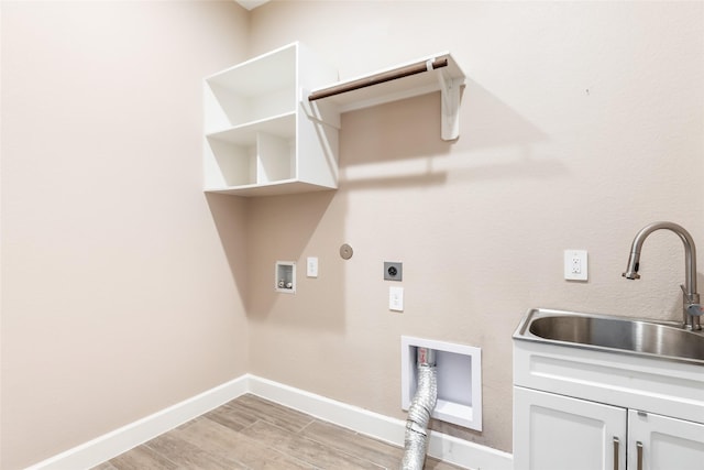23446 Timbarra Glen Dr, New Caney, TX 77357 - laundry area featuring light wood finished floors, a sink, cabinet space, electric dryer hookup, and hookup for a washing machine