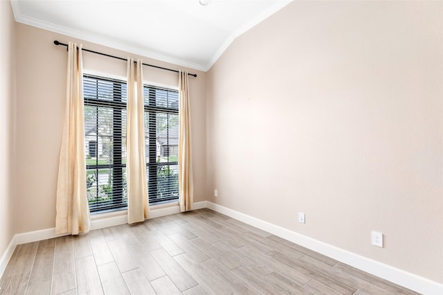 23446 Timbarra Glen Dr, New Caney, TX 77357 - empty room featuring baseboards, light wood-type flooring, crown molding, and vaulted ceiling