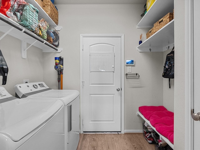 1800 Bright Way Ln, Dickinson, TX 77539 - laundry area featuring washing machine and dryer, light wood finished floors, and baseboards