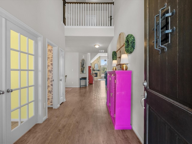 1800 Bright Way Ln, Dickinson, TX 77539 - foyer featuring wood finished floors, baseboards, and a towering ceiling