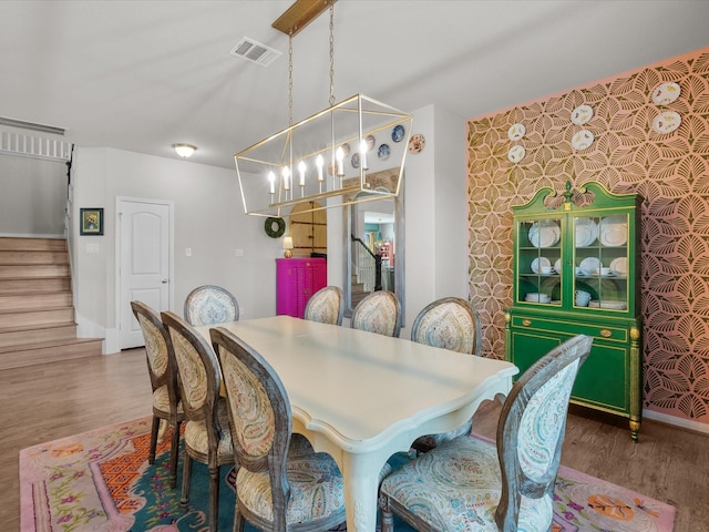 1800 Bright Way Ln, Dickinson, TX 77539 - dining room with stairway, a chandelier, wood finished floors, and baseboards