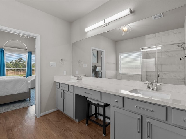 1800 Bright Way Ln, Dickinson, TX 77539 - ensuite bathroom featuring double vanity, a shower stall, and wood finished floors
