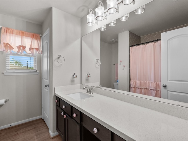 1800 Bright Way Ln, Dickinson, TX 77539 - bathroom featuring wood finished floors, vanity, baseboards, toilet, and curtained shower