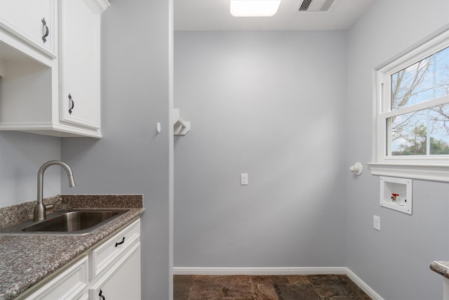 2350 Hewitt St, League City, TX 77573 - laundry area with washer hookup, baseboards, and cabinet space
