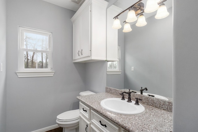 2350 Hewitt St, League City, TX 77573 - half bathroom featuring toilet, vanity, a chandelier, and baseboards