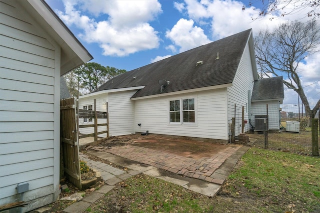 2350 Hewitt St, League City, TX 77573 - back of property with roof with shingles, a gate, a patio area, fence, and central air condition unit