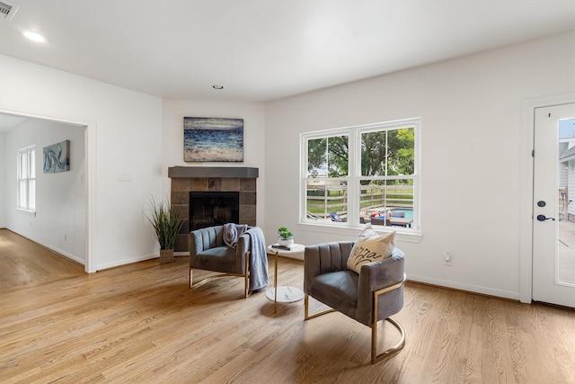 2350 Hewitt St, League City, TX 77573 - sitting room with light wood finished floors, a tile fireplace, baseboards, and recessed lighting