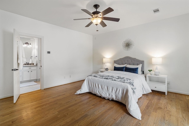 2350 Hewitt St, League City, TX 77573 - bedroom featuring light wood finished floors, baseboards, connected bathroom, and a ceiling fan
