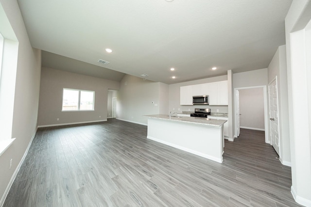kitchen with stainless steel appliances, baseboards, and visible vents