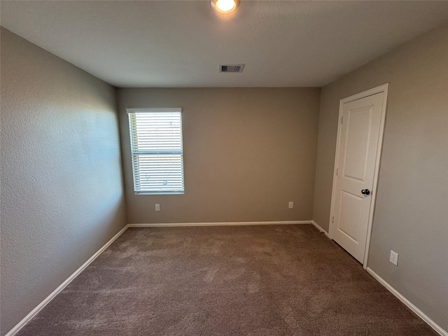 unfurnished room featuring carpet flooring, baseboards, and visible vents