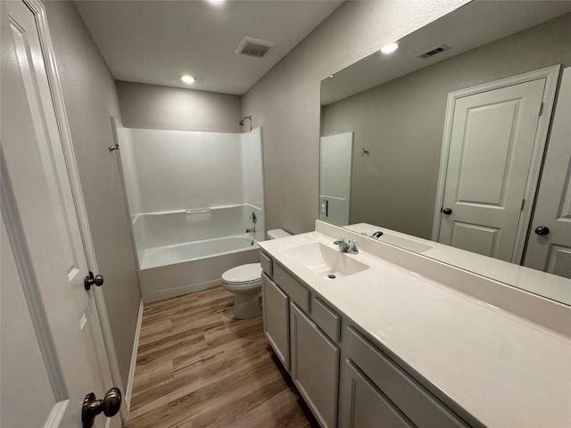 full bathroom with visible vents, toilet, bathtub / shower combination, and wood finished floors