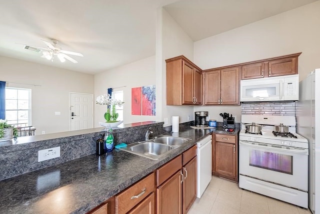 4210 Church St, Galveston, TX 77550 - kitchen featuring visible vents, a sink, a ceiling fan, white appliances, and brown cabinets