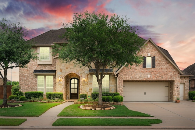 11710 Saporito Way, Richmond, TX 77406 - view of front facade with concrete driveway, a yard, brick siding, and stone siding