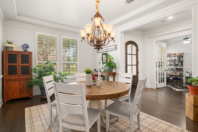 11710 Saporito Way, Richmond, TX 77406 - dining area with crown molding, arched walkways, visible vents, baseboards, and dark wood-style floors