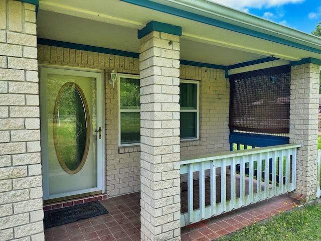 408 Redbud Rdg, Onalaska, TX 77360 - view of exterior entry featuring covered porch and brick siding