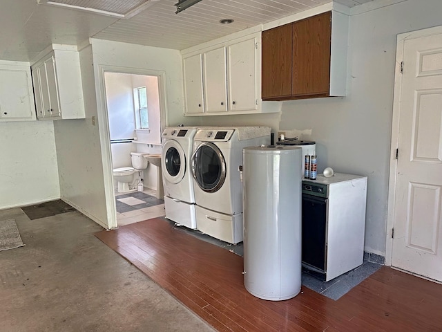408 Redbud Rdg, Onalaska, TX 77360 - laundry area with gas water heater, dark wood-style flooring, laundry area, and washing machine and dryer
