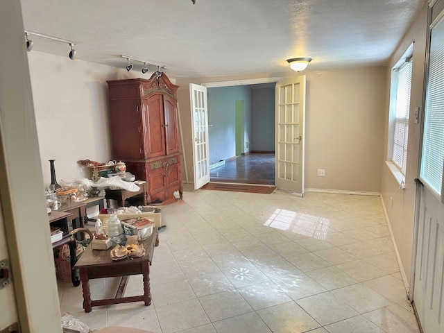 408 Redbud Rdg, Onalaska, TX 77360 - unfurnished room with track lighting, baseboards, light tile patterned flooring, and french doors