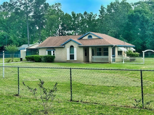 408 Redbud Rdg, Onalaska, TX 77360 - ranch-style home with roof with shingles, brick siding, fence private yard, and a front lawn