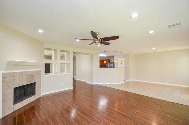 9518 Prairie Dale Ct, Houston, TX 77075 - unfurnished living room featuring a fireplace, recessed lighting, ceiling fan, wood finished floors, and baseboards