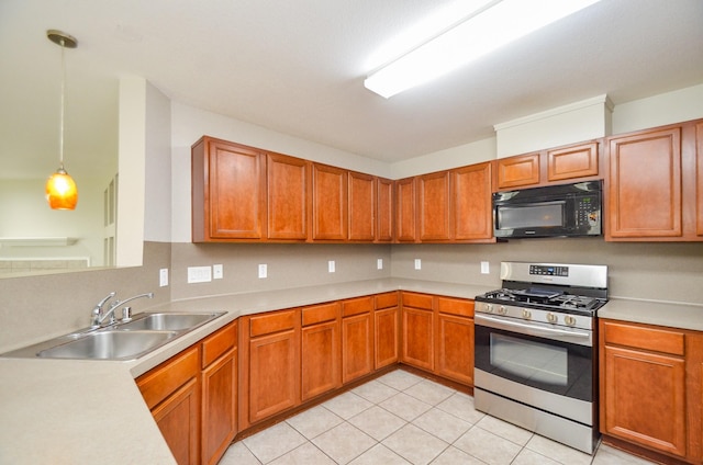 9518 Prairie Dale Ct, Houston, TX 77075 - kitchen with black microwave, gas stove, a sink, light countertops, and light tile patterned floors